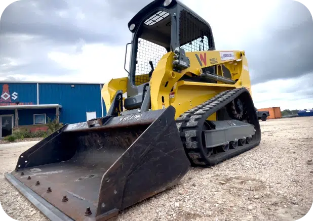 How Much Does it Cost to Rent a Skid Steer 3 Yellow compact track loader in the parking lot