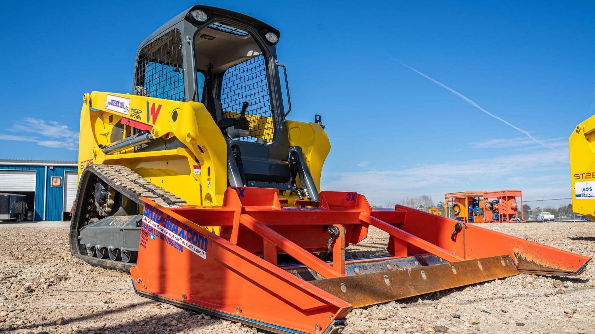 Compact track loader with a grader on the front