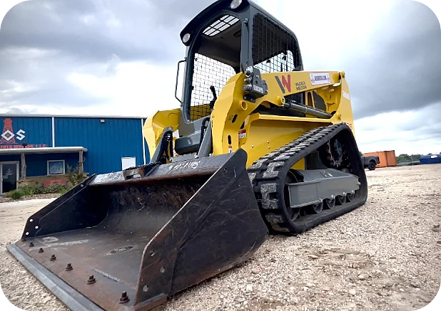 Yellow compact track loader in the parking lot