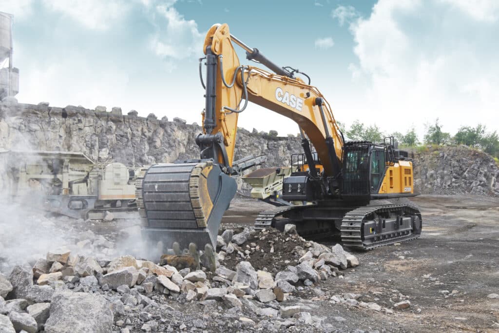 A full size excavator moving rocks.