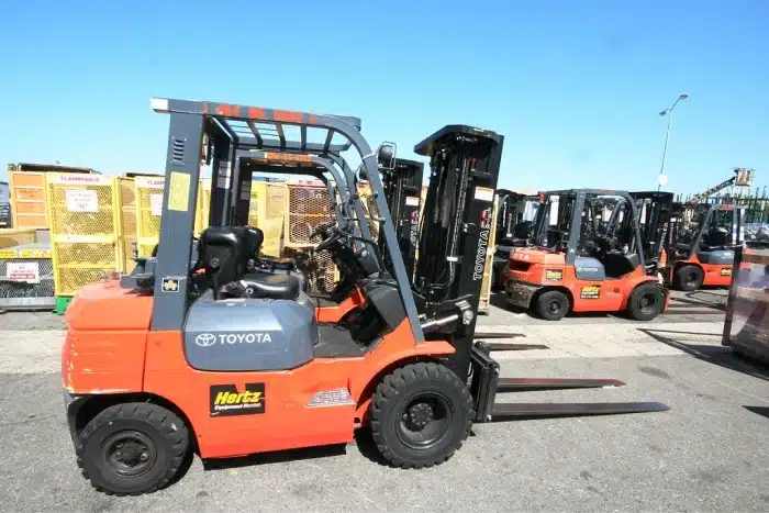 A row of forklifts at a dealership.