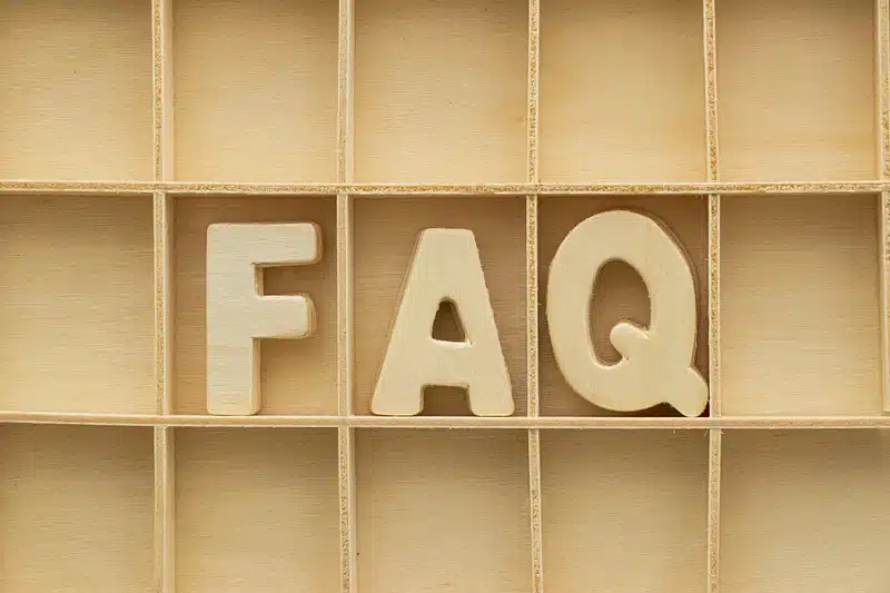 A wooden box with wooden letters that read "FAQ"