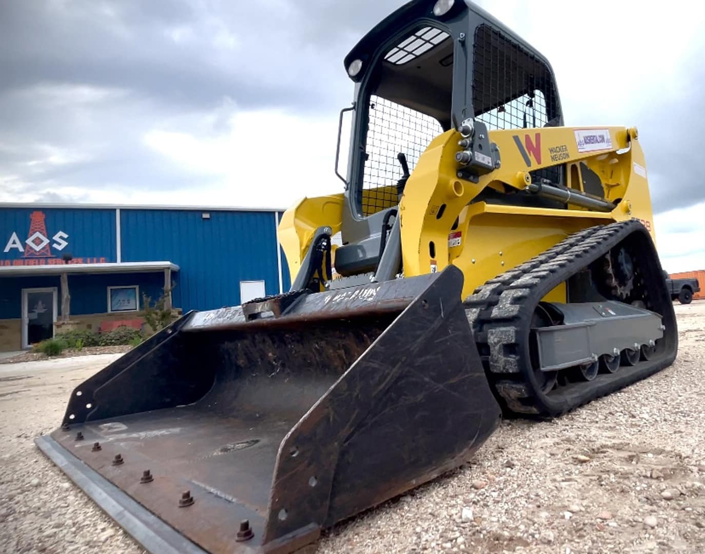 Skid steer in front of AOS Rentals in Victoria, Texas.