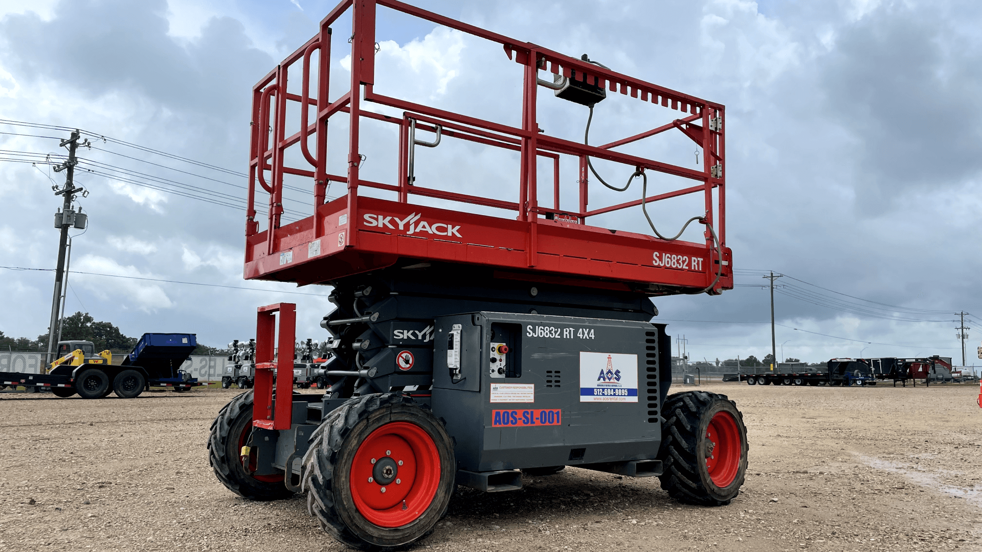 "Skyjack scissor lift," "SJ6832 RT 4x4," "all-terrain scissor lift," "elevated work platform," "construction equipment," "outdoor machinery."