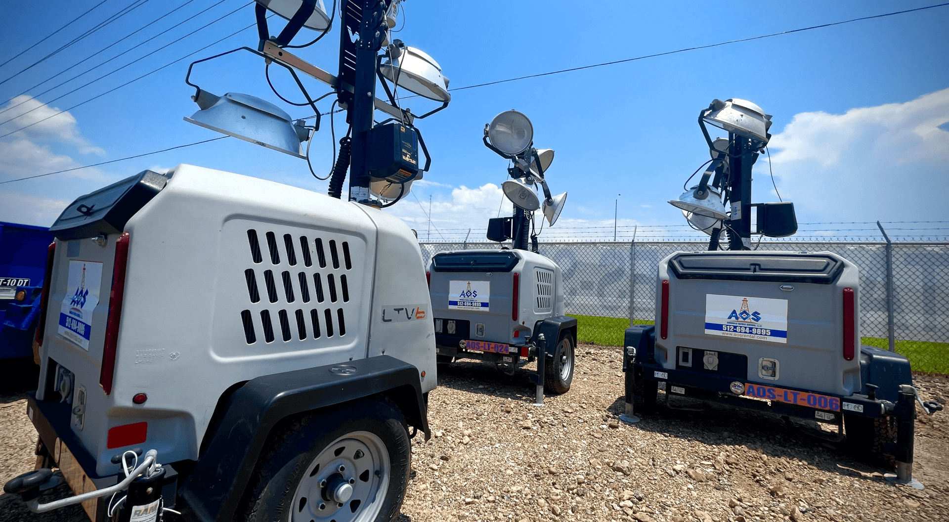 Three portable light towers parked outside.