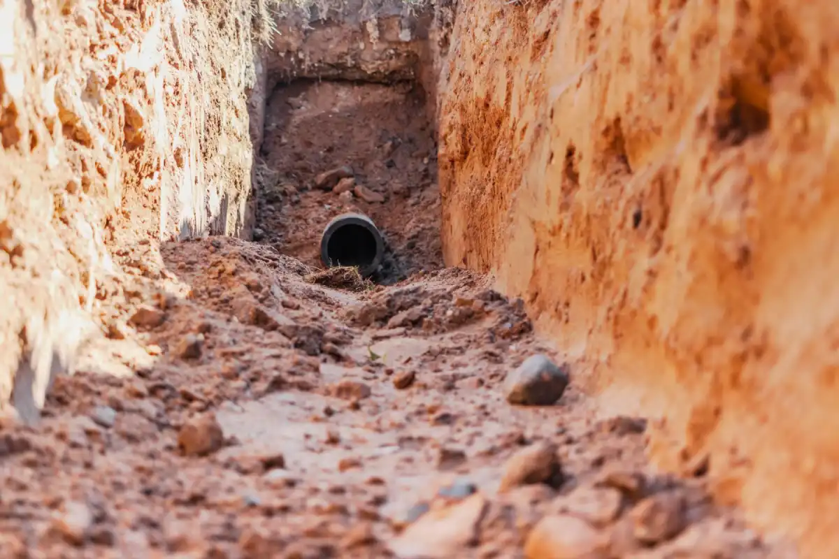 What Is A Trench? Simple Facts That Could Save Your Project. 1 Excavated trench with exposed drainage pipe