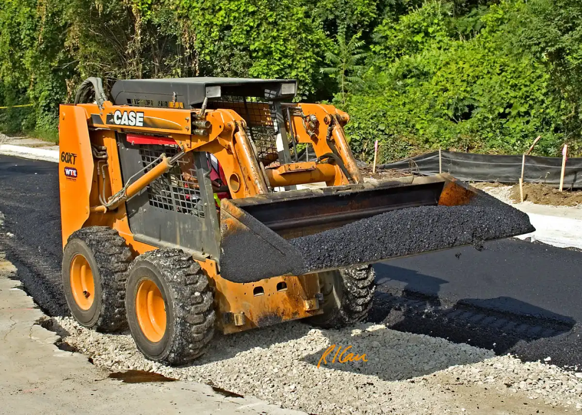 Is A Skid Steer Loader Better With Tracks Or Wheels? 1 Wheeled skid steer dumping asphalt material